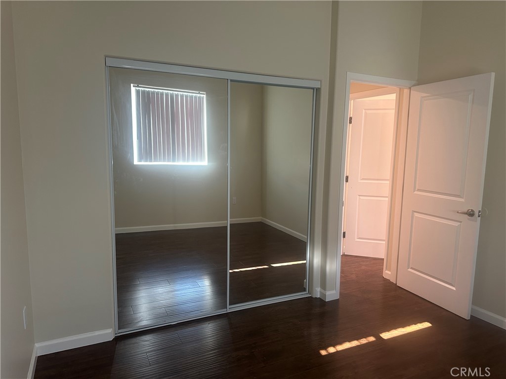 14233 Tiara Street, Unit 3 Sherman Oaks, CA 91401 - Photo 15 of 20 a view of an empty room with wooden floor and closet