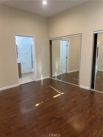a view of hallway with wooden floor