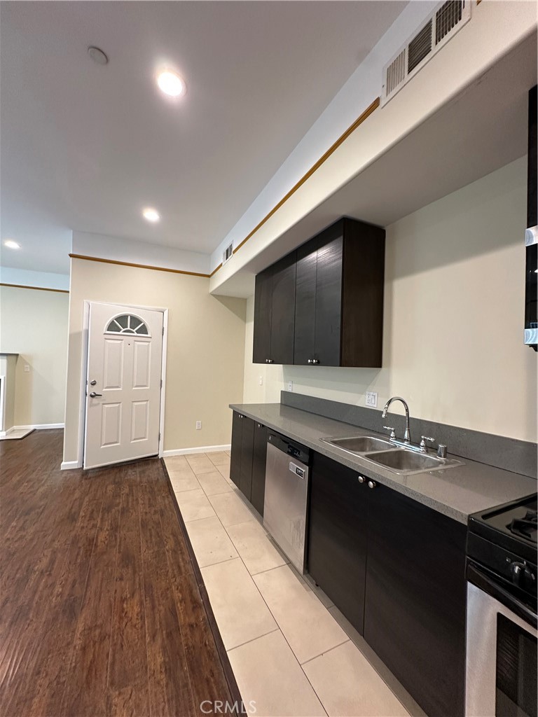 14233 Tiara Street, Unit 3 Sherman Oaks, CA 91401 - Photo 7 of 20 a living room with a flat screen tv on wall and a potted plant