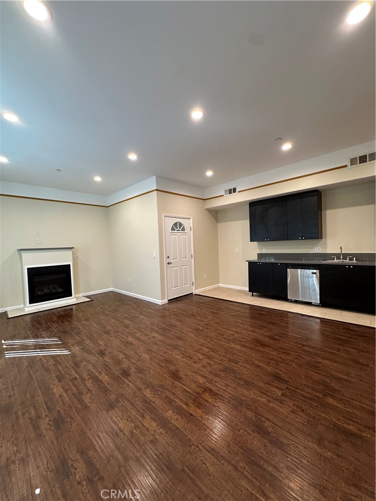 14233 Tiara Street, Unit 3 Sherman Oaks, CA 91401 - Photo 10 of 20 a view of empty room with wooden floor and fireplace