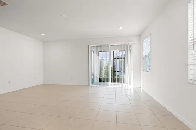 a view of kitchen with refrigerator and microwave