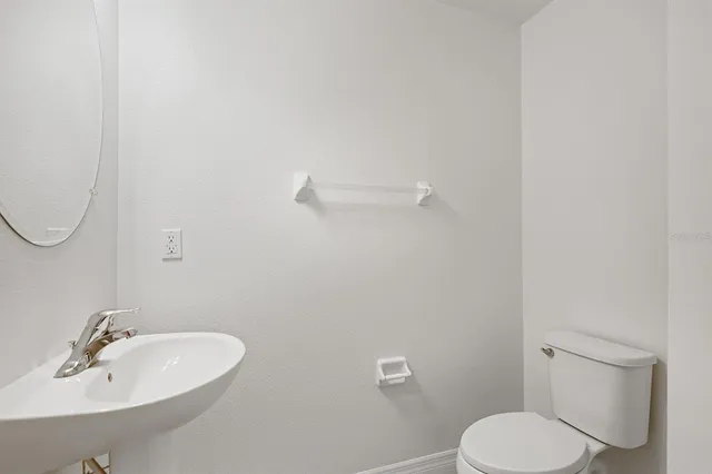 a front view of a house with swimming pool and furniture