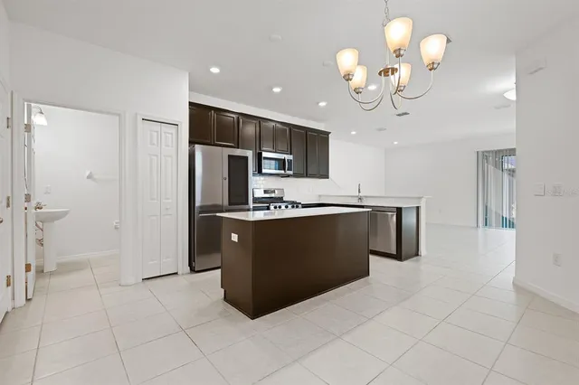 a kitchen with stainless steel appliances a stove sink microwave and cabinets