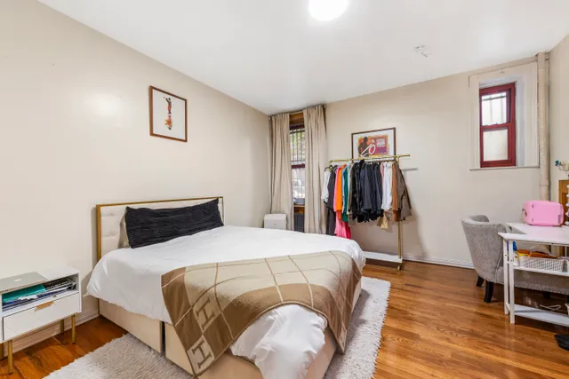 a bed room with a bed and a chair