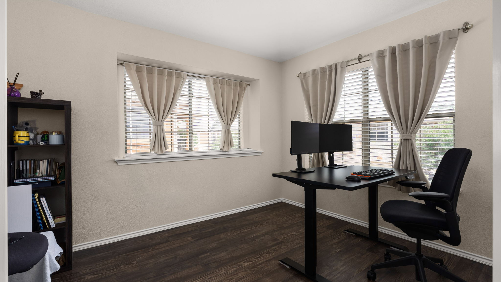 14815 Avery Ranch Boulevard, Unit 1401 Austin, TX 78717 - Photo 18 of 38 Room featuring two large windows, wood-finish flooring, and light-toned walls