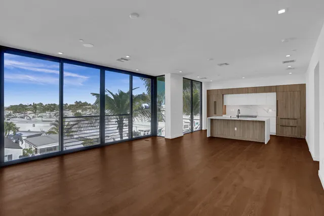 a view of a kitchen with a sink a fireplace and wooden floor