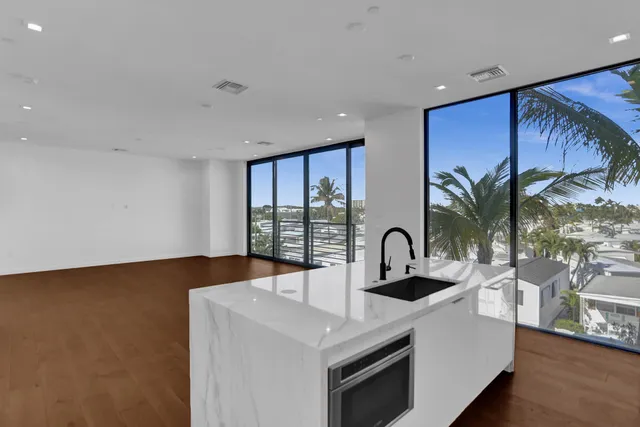 a kitchen with a sink cabinets and appliances