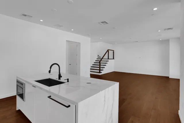 a kitchen with stainless steel appliances granite countertop a sink stove and refrigerator