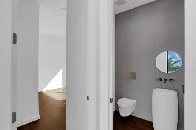 a bathroom with a toilet a sink and mirror