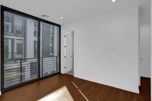 an empty room with wooden floor