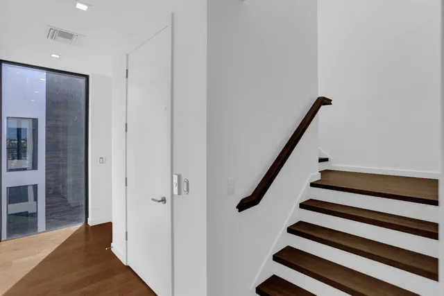a view of hallway with wooden floor