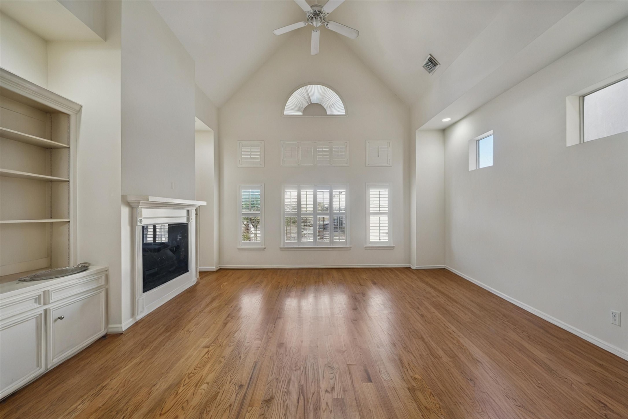 5531 Cornish Street Houston, TX 77007 - Photo 13 of 32 a view of an empty room with a fireplace and a window