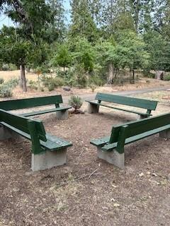 52358 Elder Road, Unit 52 Big Creek, CA 93605 - Photo 26 of 38 a view of a backyard with lawn chairs and a fire pit
