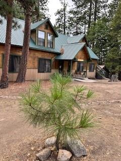 52358 Elder Road, Unit 52 Big Creek, CA 93605 - Photo 31 of 38 a front view of a house with a yard and garage