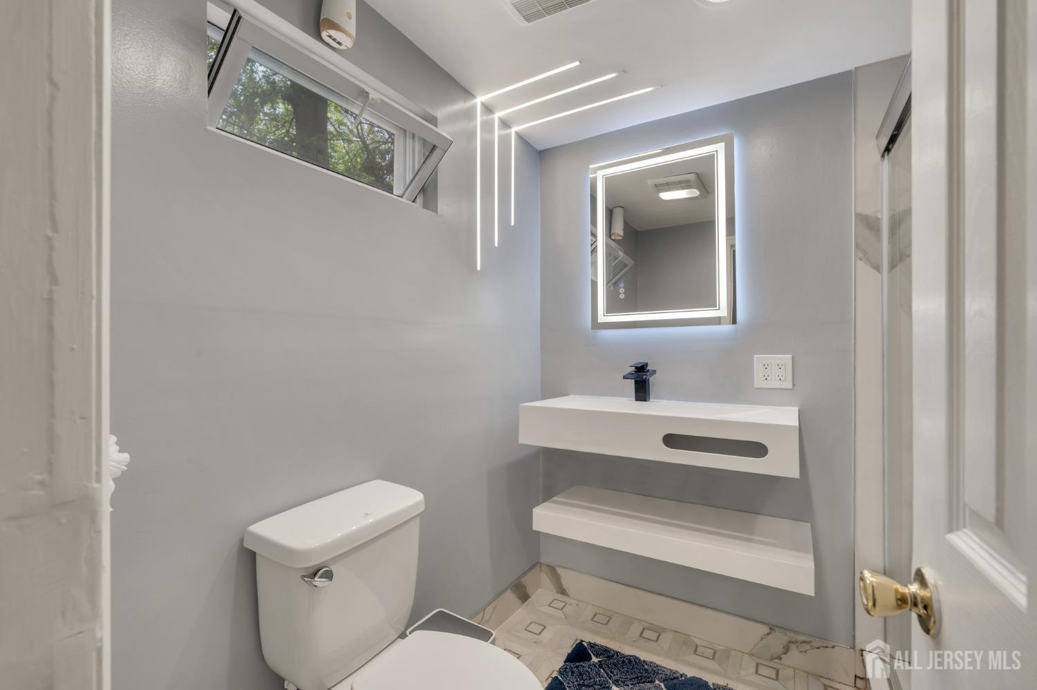 12 Pierrepont Avenue Middlesex, NJ 08846 - Photo 20 of 30 a bathroom with a toilet a sink and a mirror