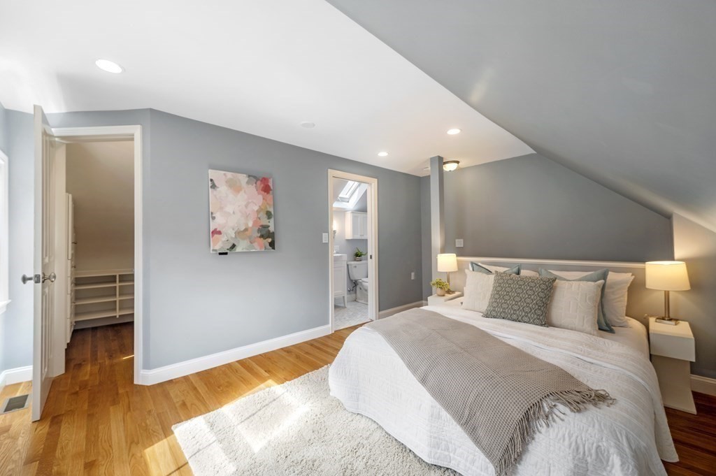2 Reed St Court, Unit 2 Cambridge, MA 02140 - Photo 16 of 31 a bedroom with a large bed and a chandelier