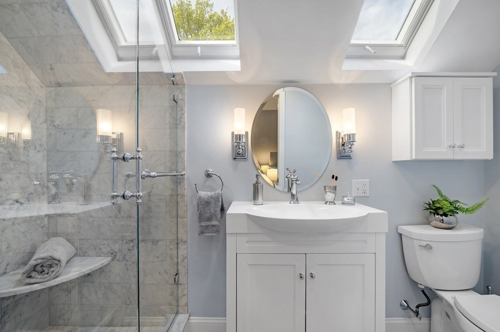 2 Reed St Court, Unit 2 Cambridge, MA 02140 - Photo 18 of 31 a bathroom with a sink a toilet and a mirror