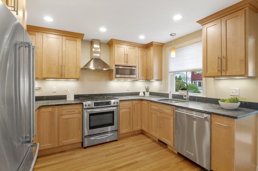 2 Reed St Court, Unit 2 Cambridge, MA 02140 - Photo 6 of 31 a kitchen with stainless steel appliances granite countertop a stove a sink and a microwave
