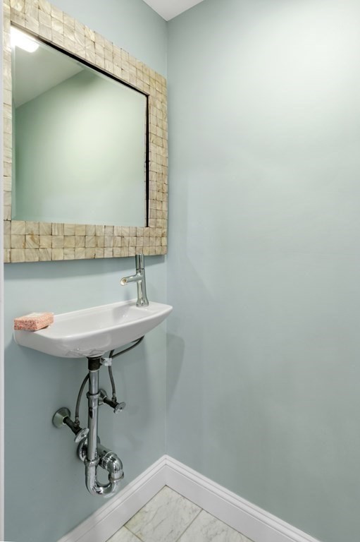 2 Reed St Court, Unit 2 Cambridge, MA 02140 - Photo 9 of 31 a bathroom with a sink a mirror and a toilet