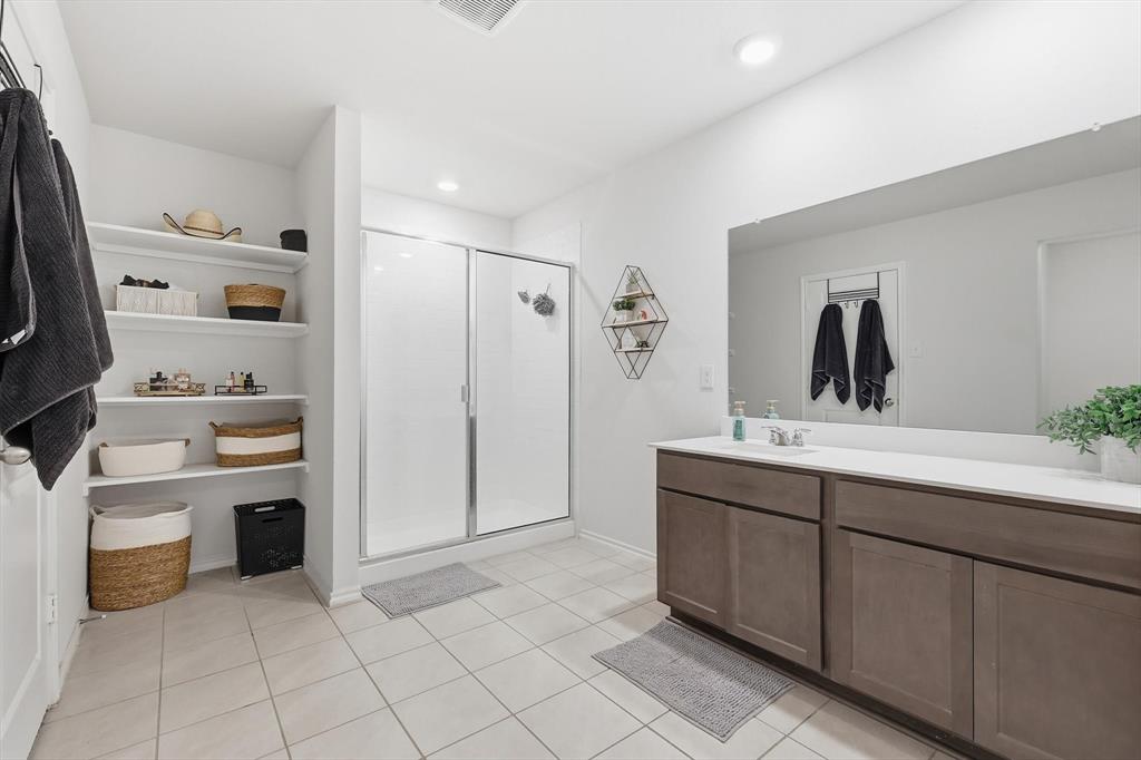 2416 Wildhaven Road Crandall, TX 75114 - Photo 18 of 35 a spacious bathroom with a double vanity sink and a mirror