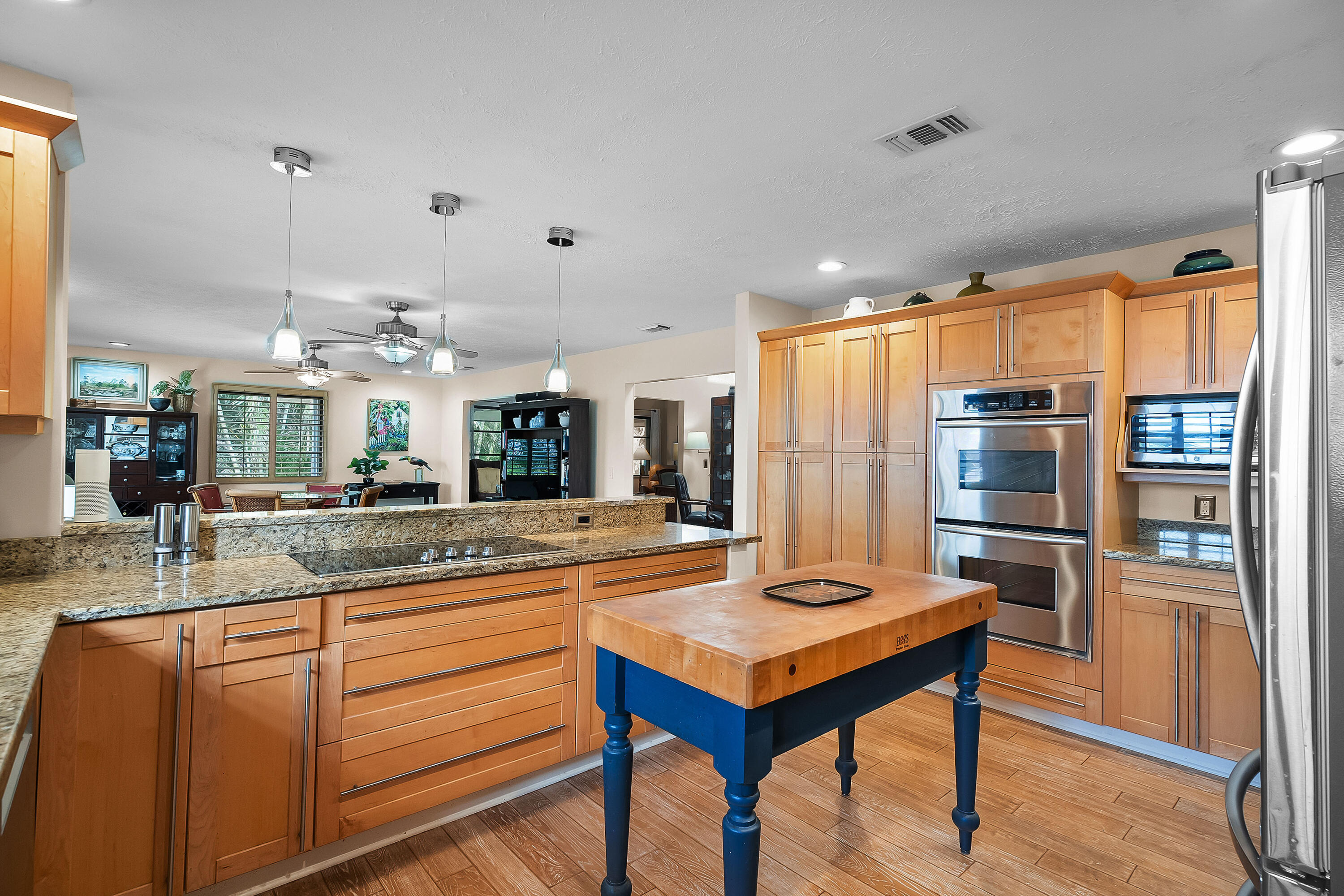 5105 Southeast Matousek Street Stuart, FL 34997 - Photo 16 of 48 a kitchen with stainless steel appliances granite countertop a refrigerator and a stove top oven