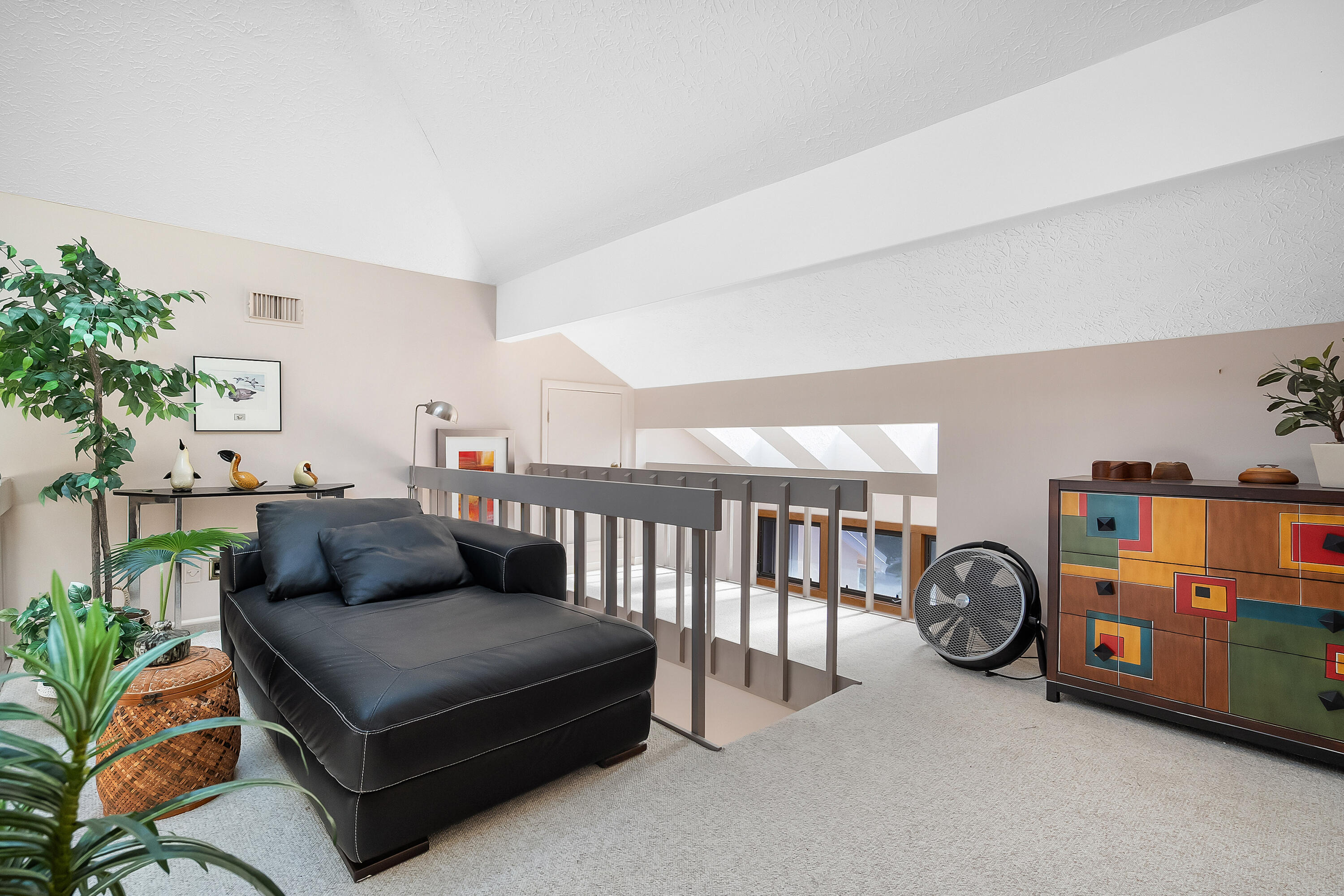 5105 Southeast Matousek Street Stuart, FL 34997 - Photo 22 of 48 a living room with furniture a table and a potted plant