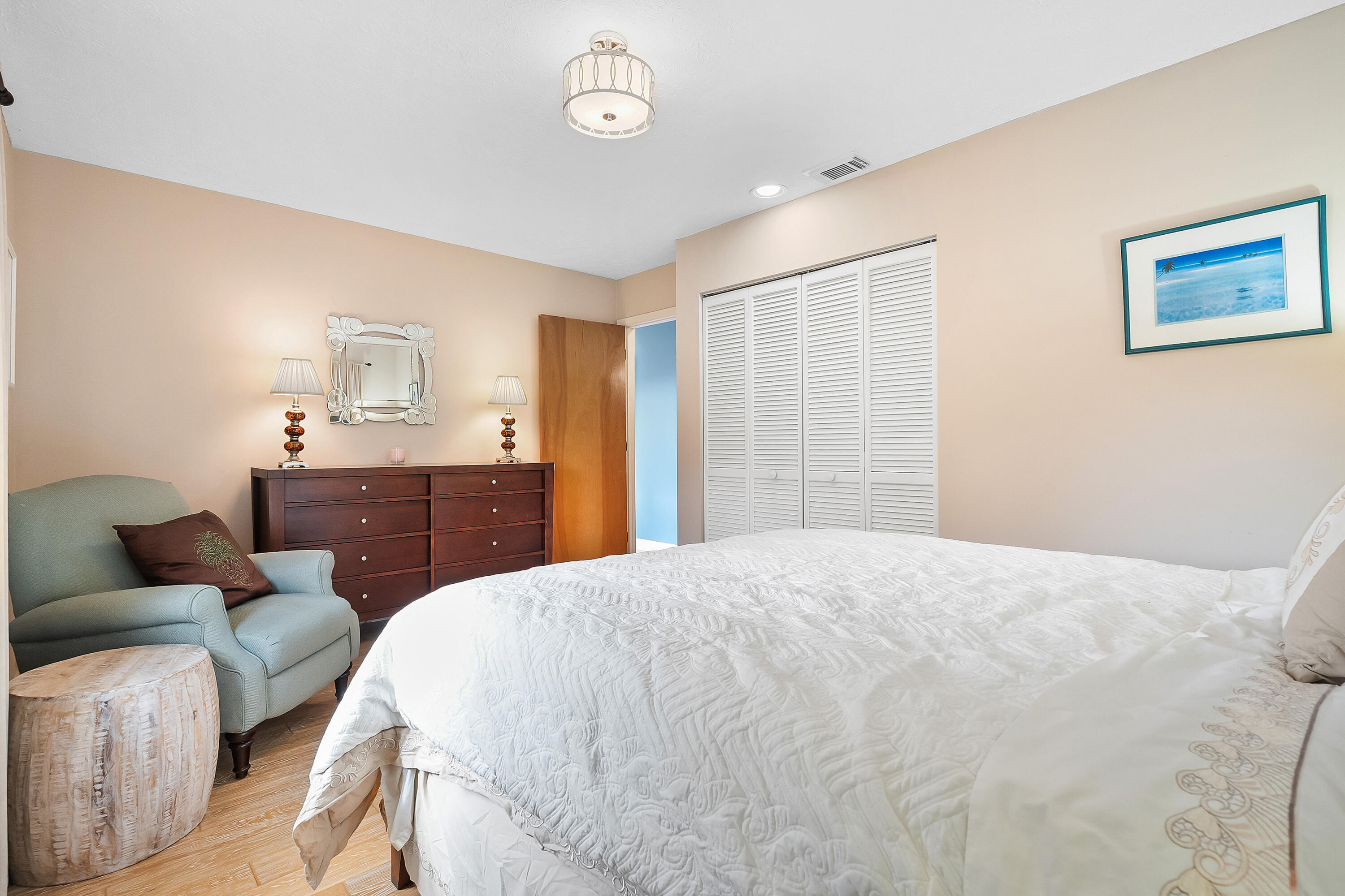 5105 Southeast Matousek Street Stuart, FL 34997 - Photo 26 of 48 a spacious bedroom with a bed and furniture