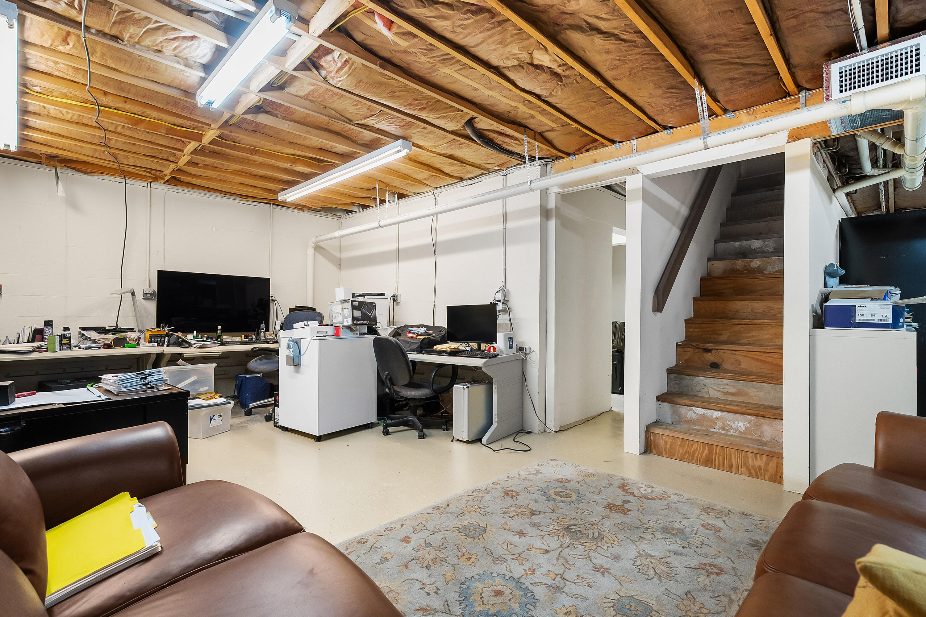 5105 Southeast Matousek Street Stuart, FL 34997 - Photo 28 of 48 a living room with furniture and a flat screen tv