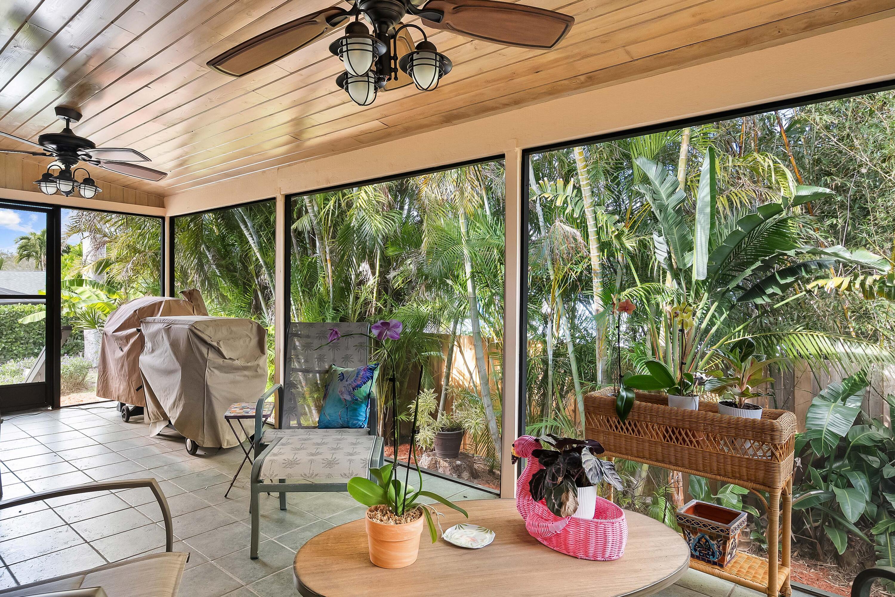 5105 Southeast Matousek Street Stuart, FL 34997 - Photo 30 of 48 a view of a patio with dining table and chairs