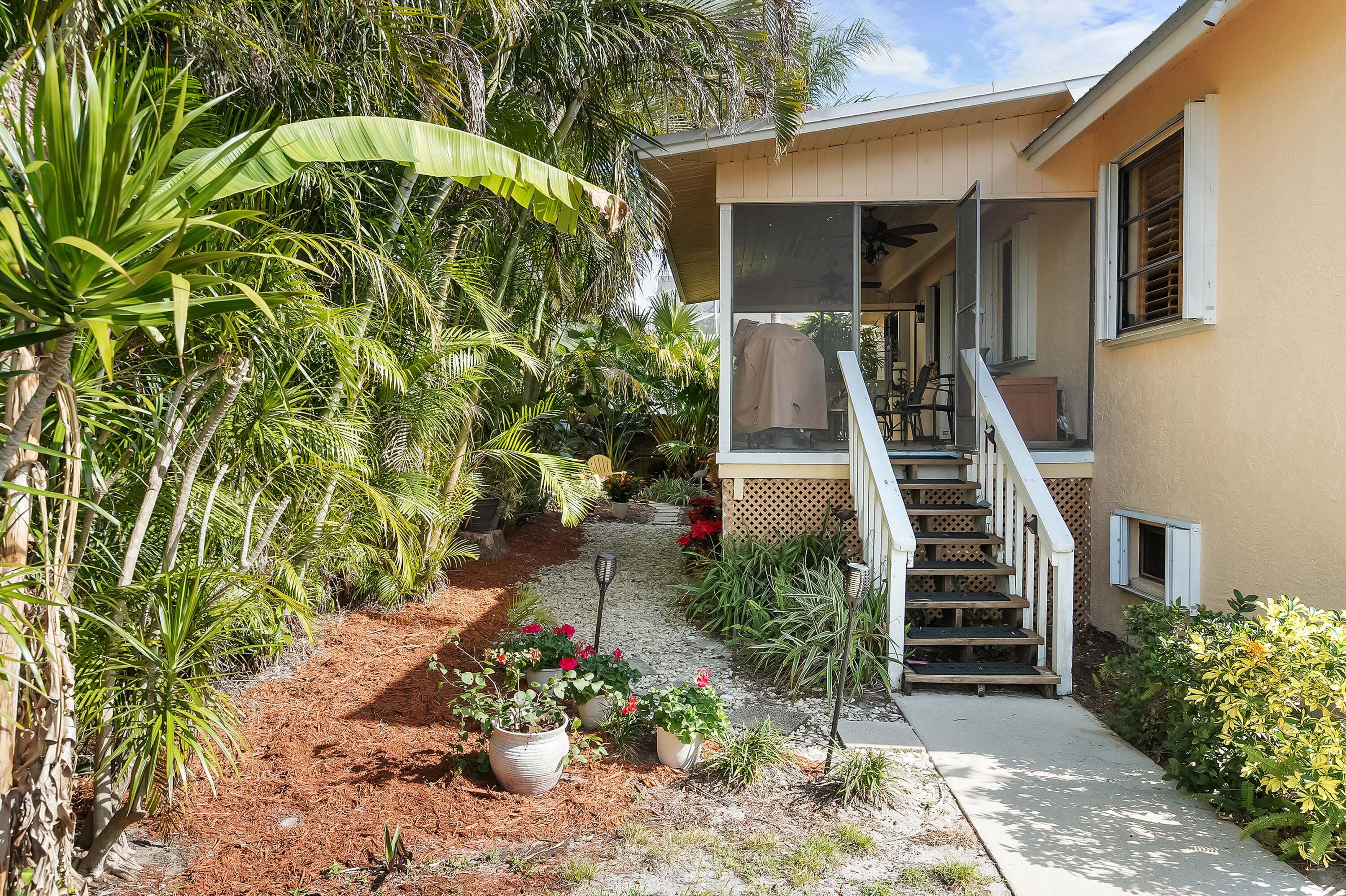 5105 Southeast Matousek Street Stuart, FL 34997 - Photo 32 of 48 a view of a house with entrance and plants