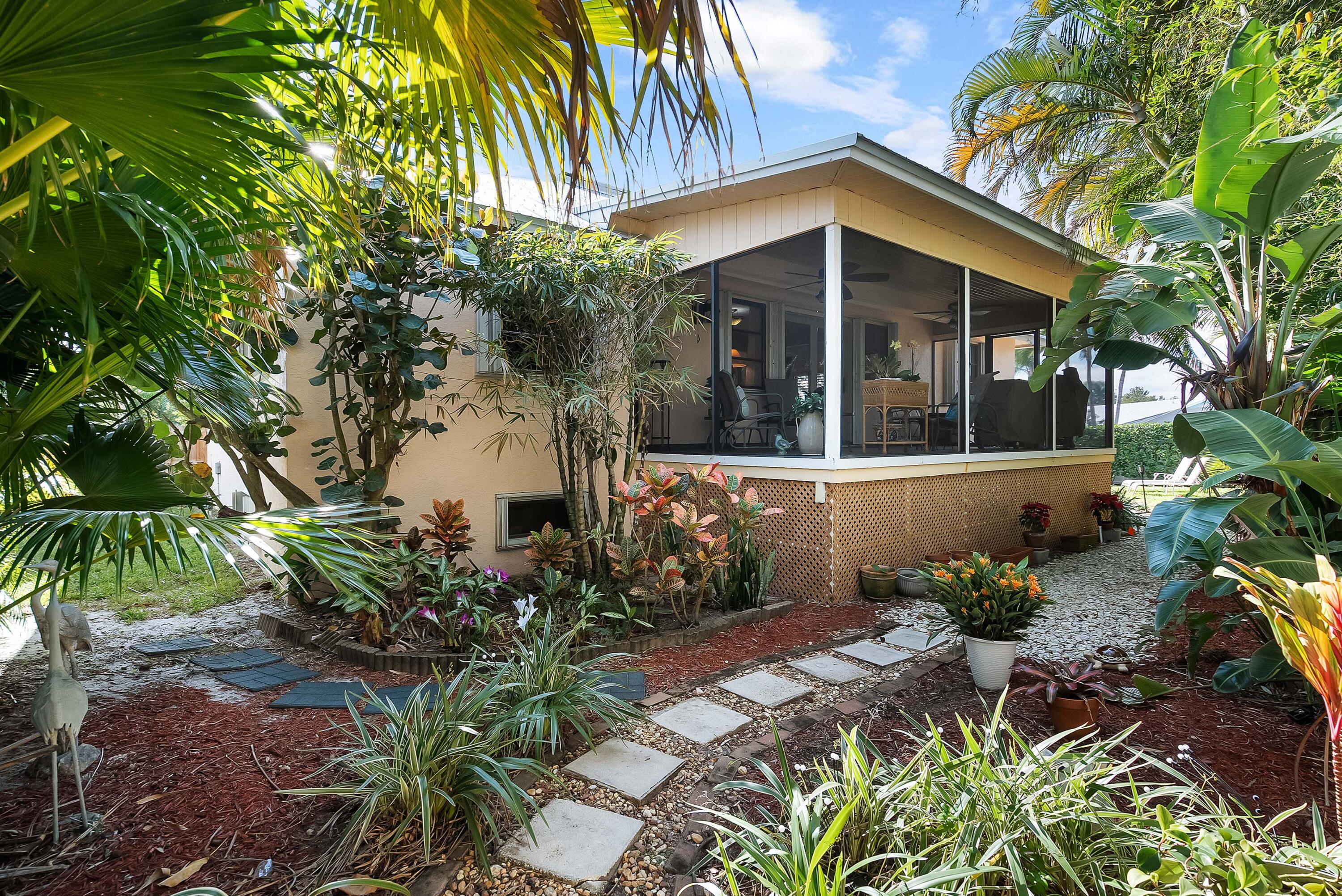 5105 Southeast Matousek Street Stuart, FL 34997 - Photo 34 of 48 a front view of a house with a yard