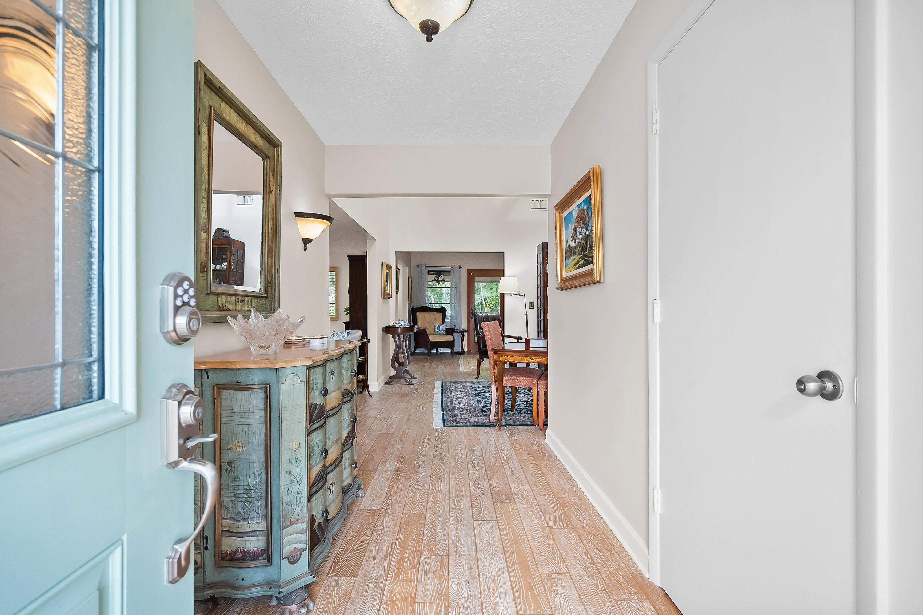5105 Southeast Matousek Street Stuart, FL 34997 - Photo 8 of 48 a view of hallway with furniture and wooden floor
