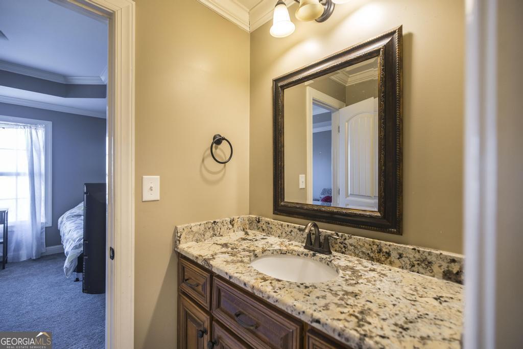 4065 Gordon Road Abbeville, GA 31001 - Photo 32 of 48 a bathroom with a granite countertop sink and a mirror