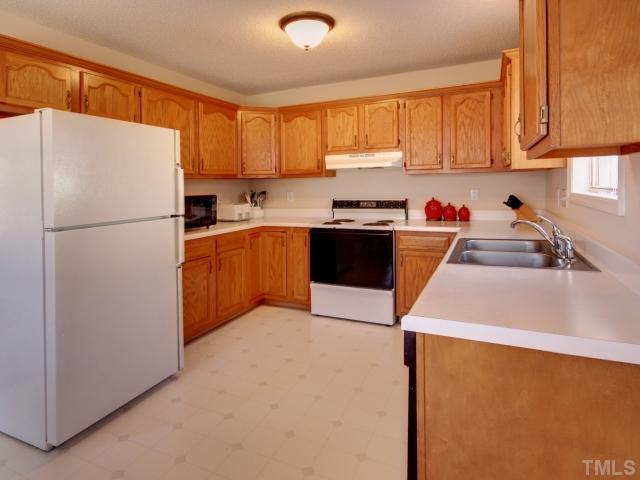5633 Lighthall Lane Raleigh, NC 27604 - Photo 4 of 11 Kitchen with three walls of cabinet and counterspace and double sink.