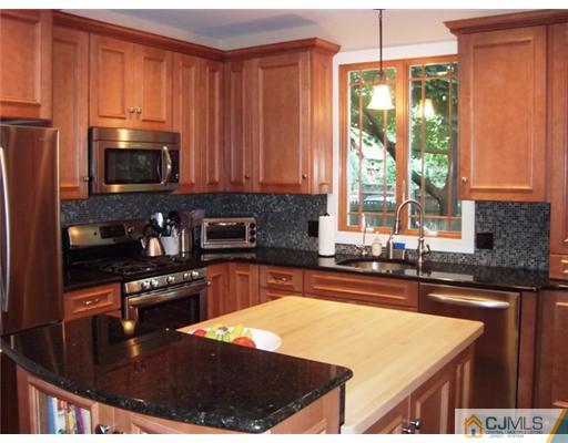 61 Jefferson Road Mercer County, NJ 08540 - Photo 1 of 15 a kitchen with stainless steel appliances granite countertop a stove a sink and a microwave