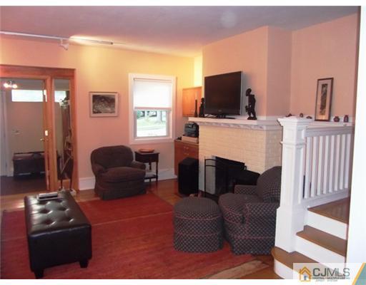 61 Jefferson Road Mercer County, NJ 08540 - Photo 8 of 15 a living room with furniture a flat screen tv and a fireplace