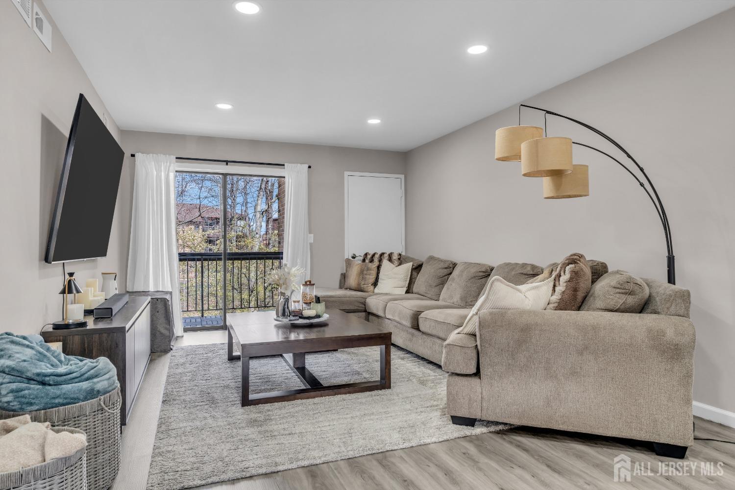 1933 Raspberry Court Edison, NJ 08817 - Photo 1 of 30 a living room with furniture and a flat screen tv