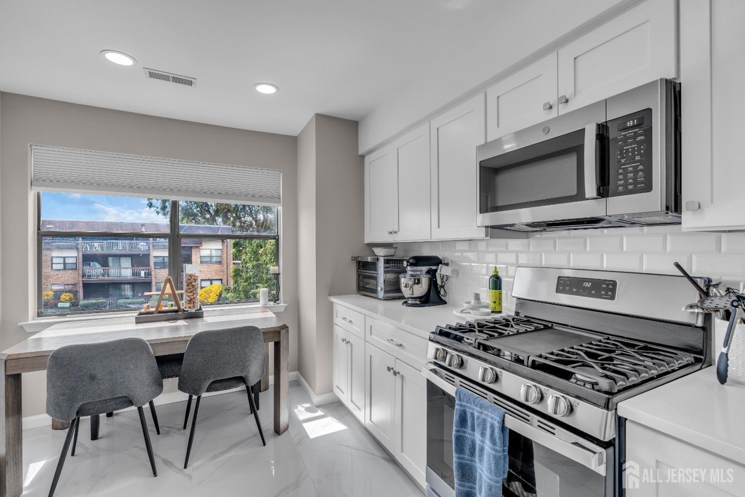 1933 Raspberry Court Edison, NJ 08817 - Photo 11 of 30 a kitchen with stainless steel appliances a stove a sink cabinets and a microwave