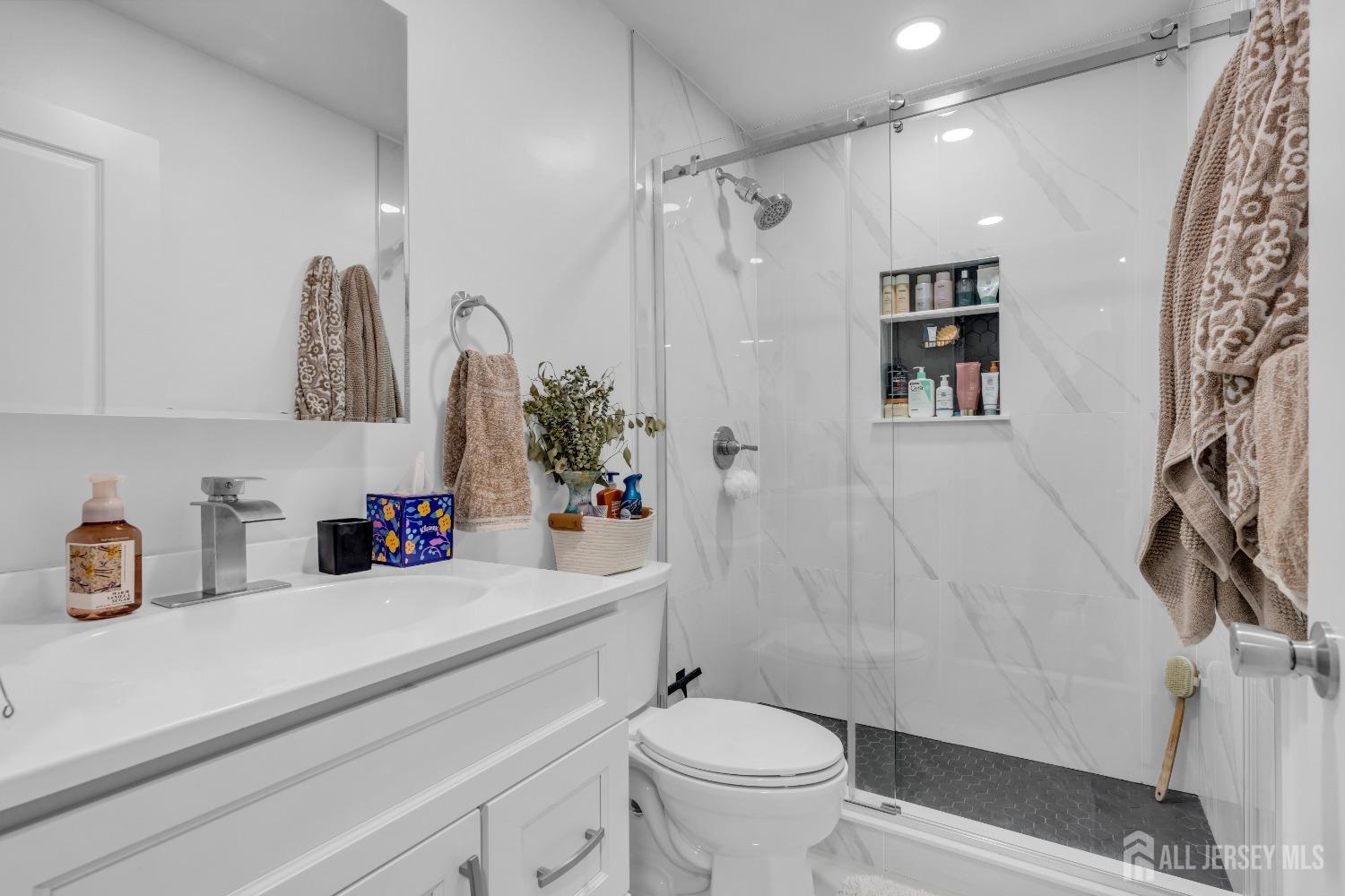 1933 Raspberry Court Edison, NJ 08817 - Photo 24 of 30 a bathroom with a sink a toilet and shower curtain