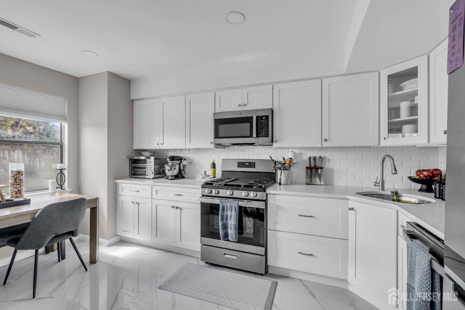1933 Raspberry Court Edison, NJ 08817 - Photo 9 of 30 a kitchen with white cabinets stainless steel appliances and sink