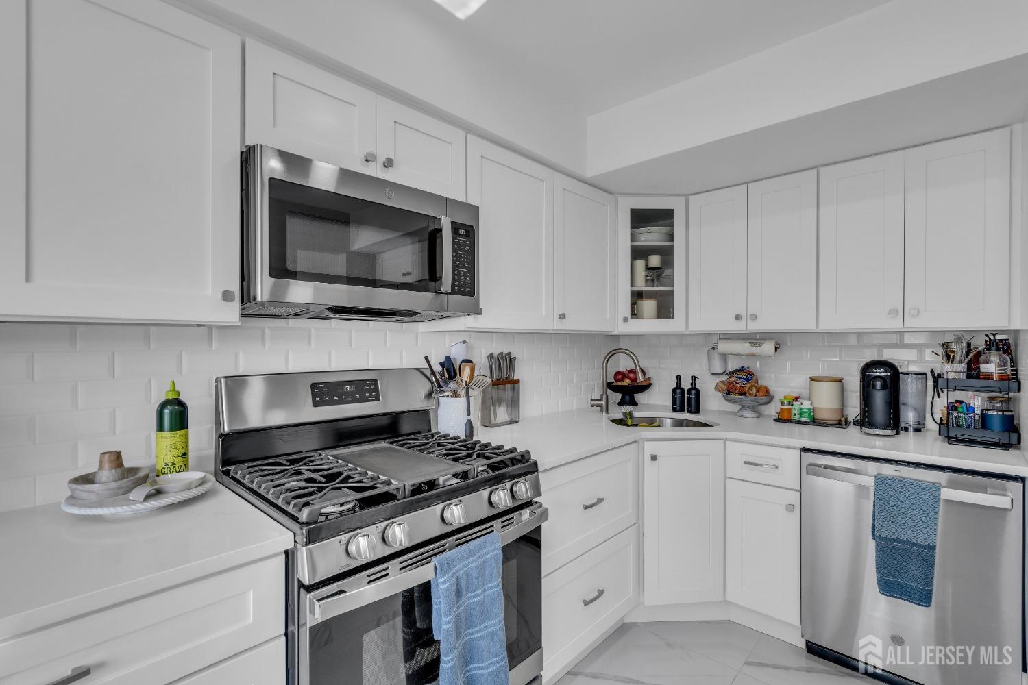 1933 Raspberry Court Edison, NJ 08817 - Photo 10 of 30 a kitchen with white cabinets and appliances