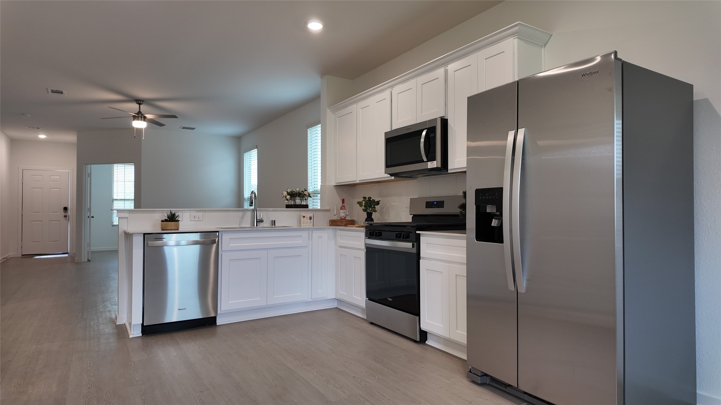 15023 Rustic Moon Road Conroe, TX 77302 - Photo 6 of 18 a kitchen with a refrigerator stove and microwave
