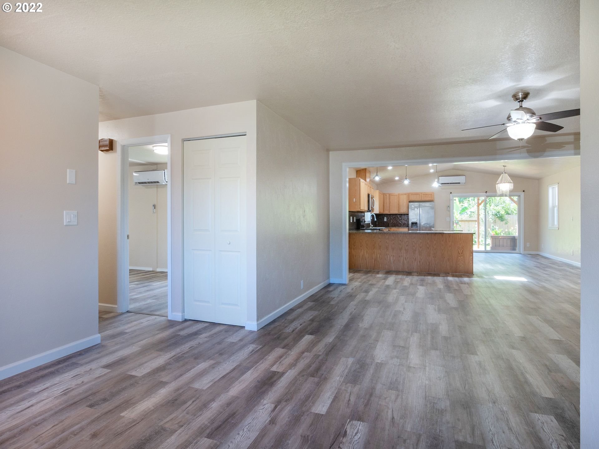467 Mansfield Street Springfield, OR 97477 - Photo 4 of 32 a view of a big room with wooden floor and a kitchen