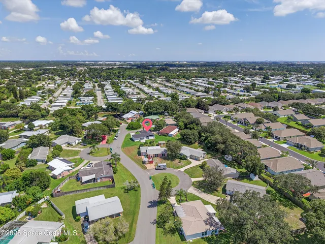 an aerial view of residential houses with outdoor space and street view