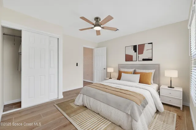 a bedroom with a bed and a ceiling fan