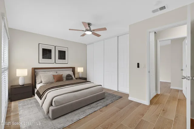 a bedroom with a large bed and a chandelier