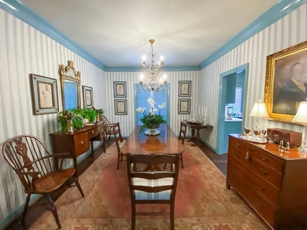 a view of a dining room with furniture and chandelier