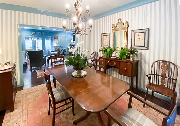 a view of a dining room with furniture and a chandelier