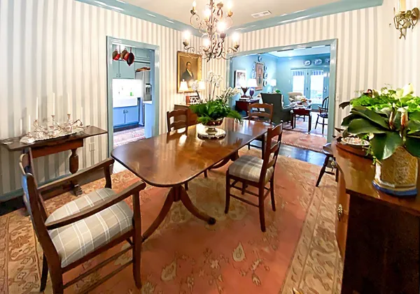 a living room with furniture and a wall painting