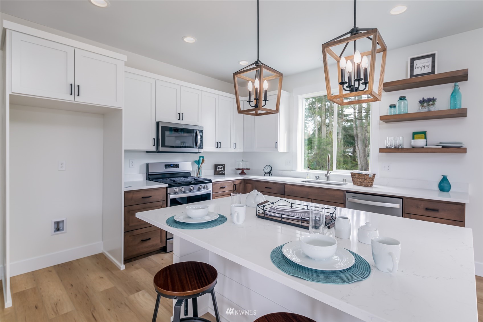 2284 South 19th Street Mount Vernon, WA 98274 - Photo 17 of 29 a kitchen with stainless steel appliances granite countertop a kitchen island hardwood floor sink stove and cabinets